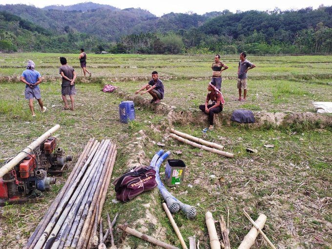 In this picture shared on social media, Longtsiri villagers are seen along with the seized equipment allegedly brought for illegal oil exploration at the site of the incident on April 25. (Source: WhatsApp)